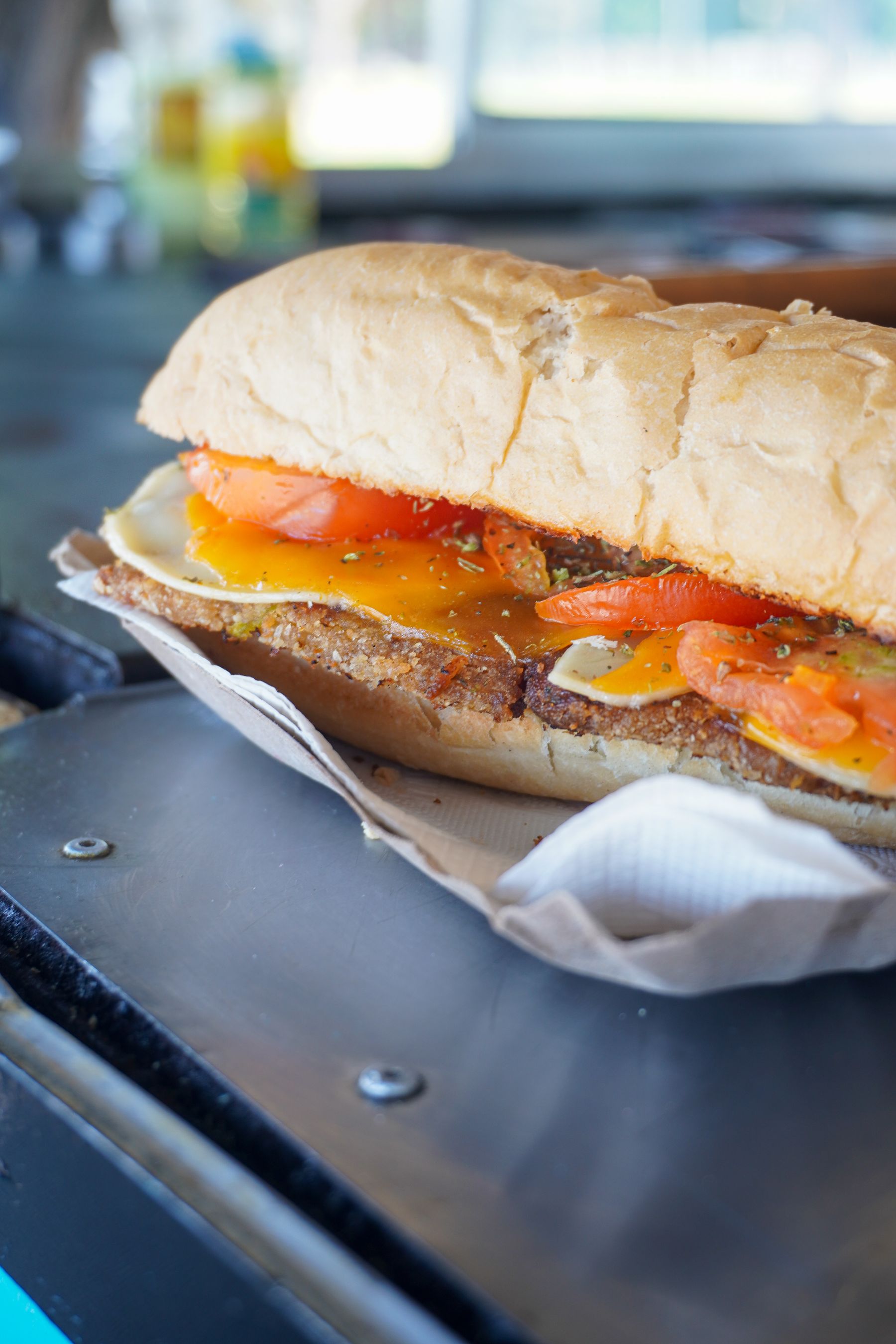 A toasted sandwich layered with cheese and tomatoes